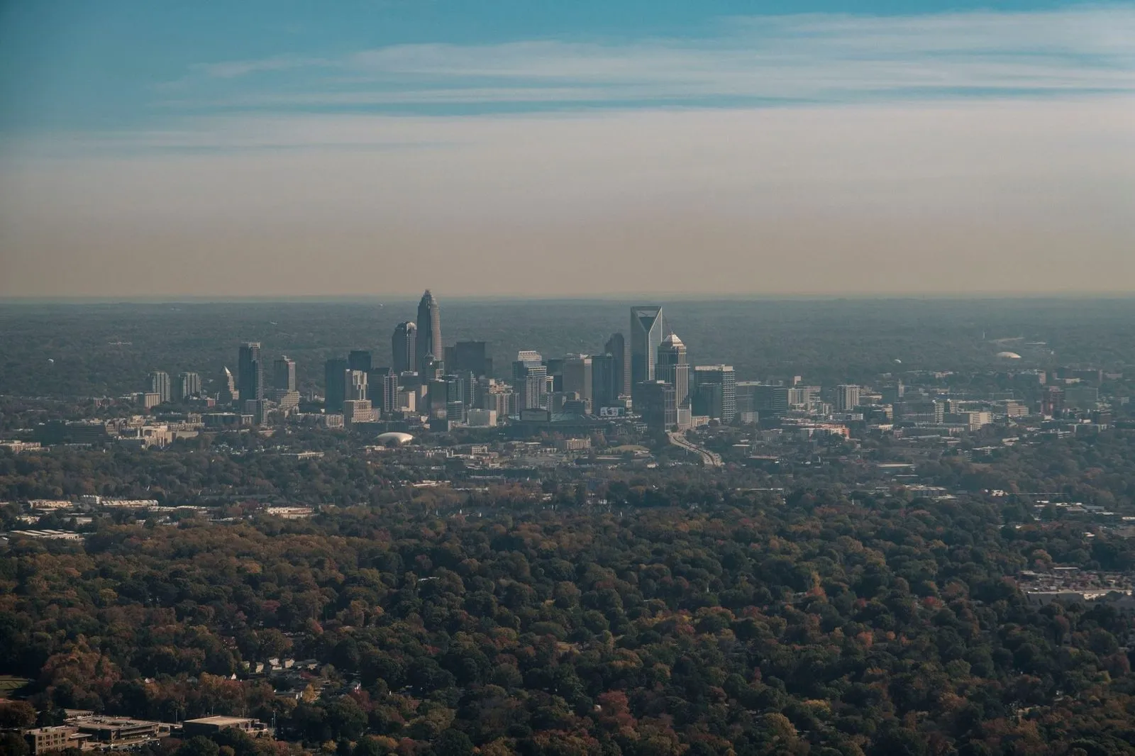 The cluster of uptown Charlotte towers against an open sky