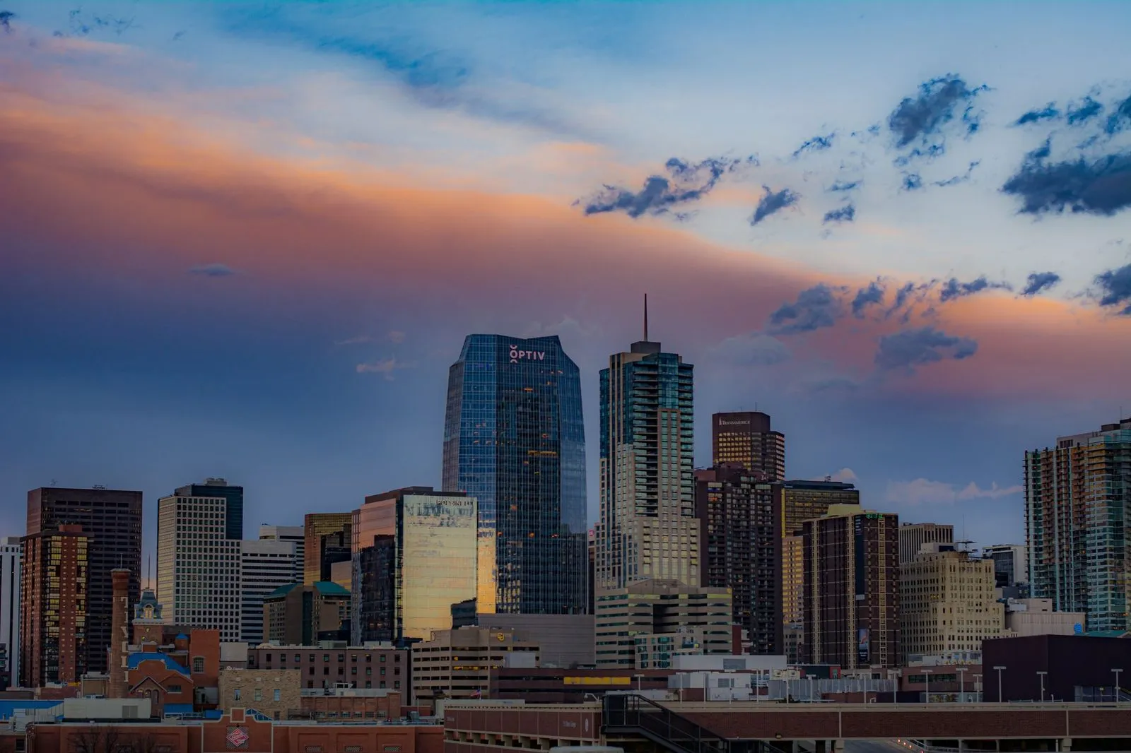 Denver office towers with the Rocky Mountains behind them