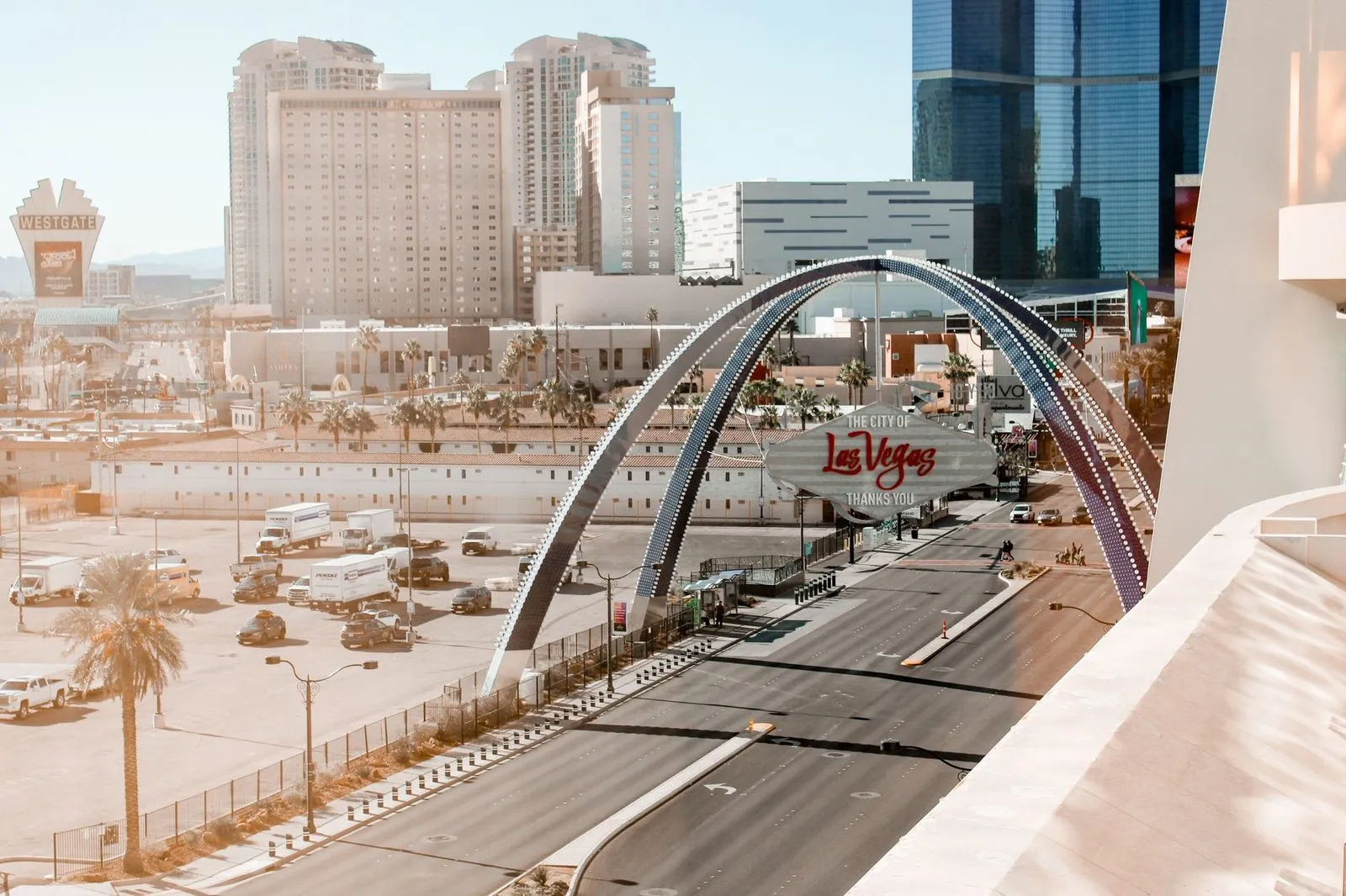 The Las Vegas Boulevard welcome sign with desert and hotels behind it