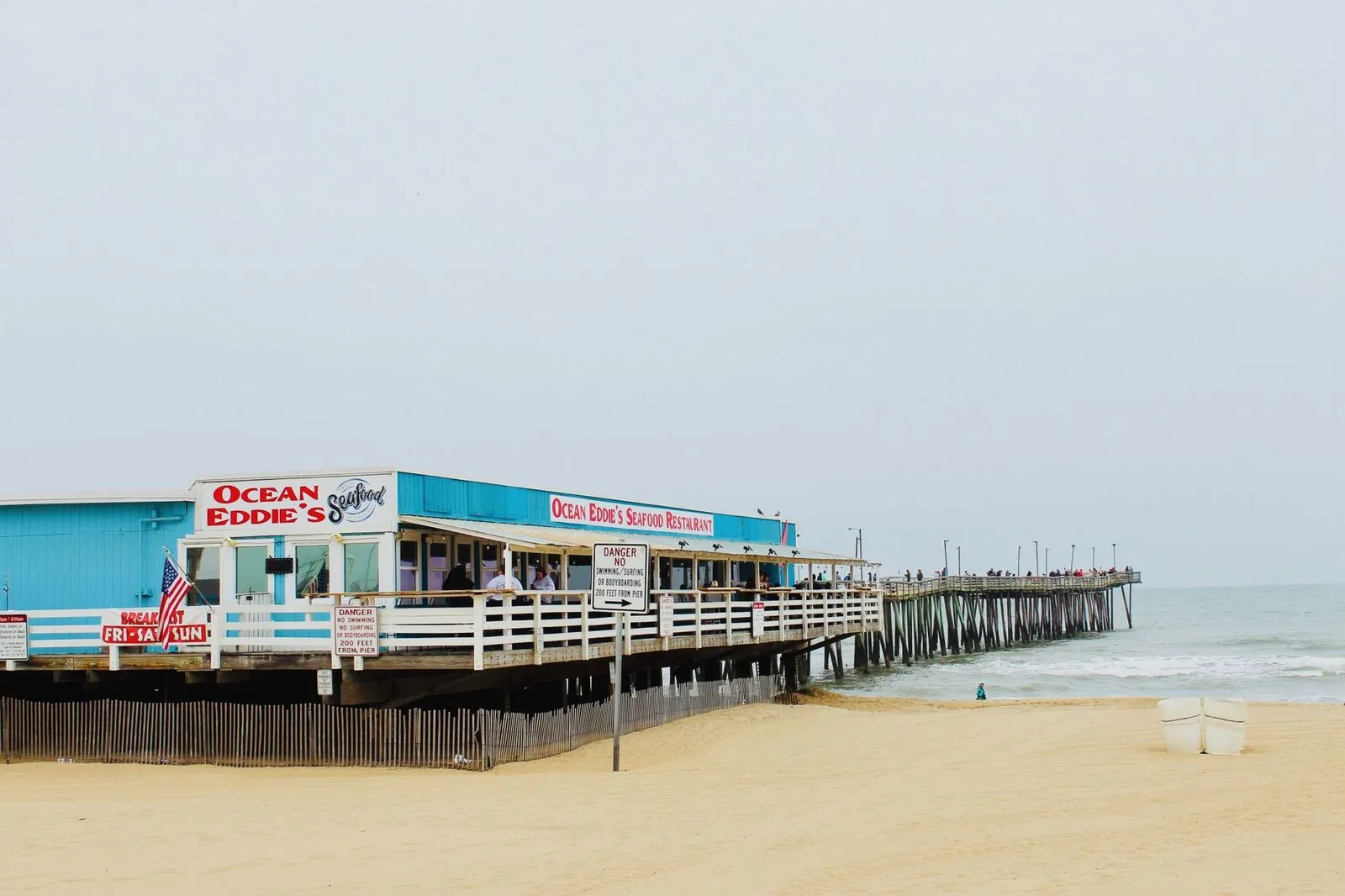 A wooden fishing pier running out over the ocean at Virginia Beach